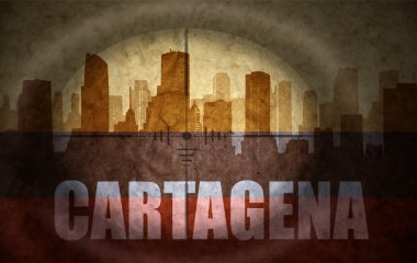 sniper scope aimed at the abstract silhouette of the city with text Cartagena at the vintage colombian flag. concept