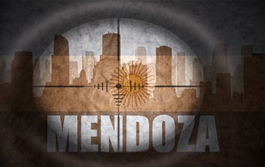 sniper scope aimed at the abstract silhouette of the city with text Mendoza at the vintage argentinian flag. concept