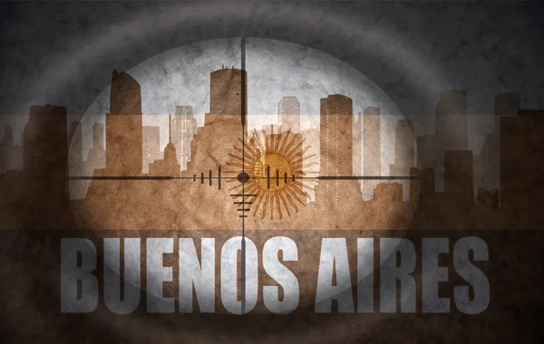 Sniper scope aimed at the abstract silhouette of the city with text Buenos Aires at the vintage argentinian flag. concept — 图库照片