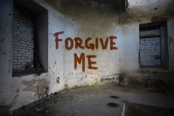 Text forgive me on the dirty old wall in an abandoned ruined house — Stock Photo, Image