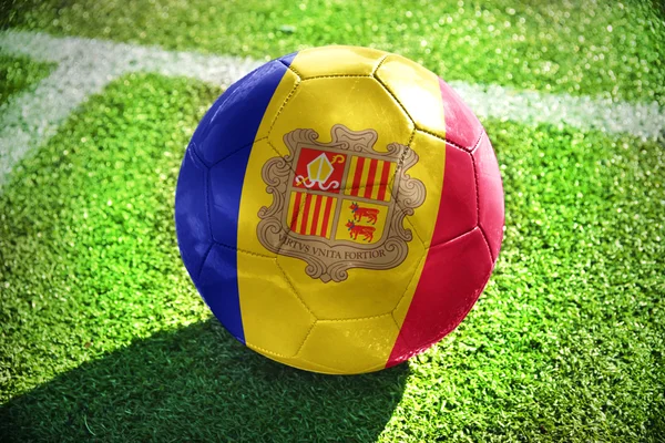 Football ball with the national flag of andorra  on the field — Zdjęcie stockowe