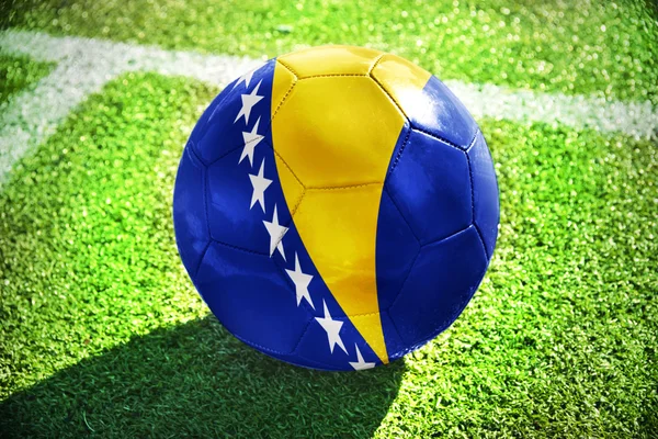 Football ball with the national flag of bosnia and herzegovina on the field — Stok fotoğraf