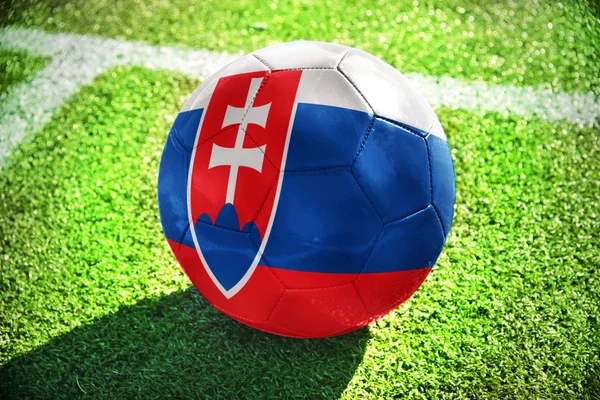 Football ball with the national flag of slovakia on the field — Stockfoto