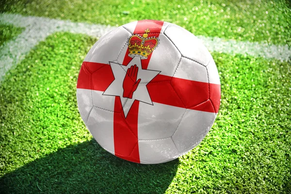 Football ball with the national flag of northern ireland on the field — Stock Photo, Image