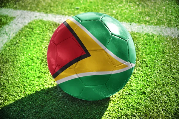 Football ball with the national flag of guyana on the field — Stock Photo, Image