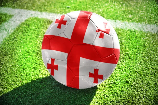 Football ball with the national flag of Georgia on the field — Stock Photo, Image