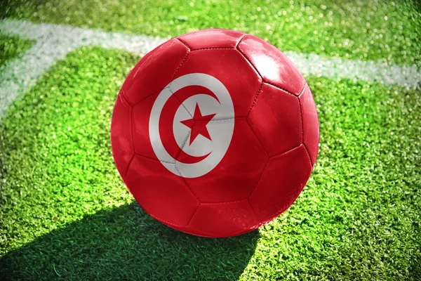Football ball with the national flag of tunisia — Stok fotoğraf
