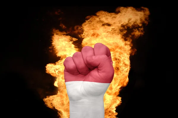 Fire fist with the national flag of indonesia — Stock Photo, Image