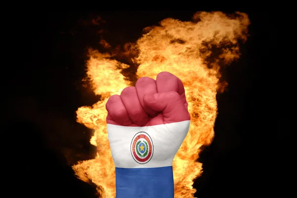 Punho de fogo com a bandeira nacional do paraguai — Fotografia de Stock