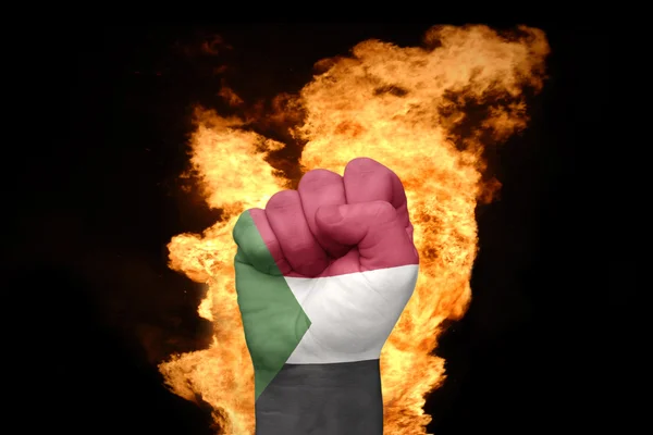 Fire fist with the national flag of sudan — Stock Photo, Image