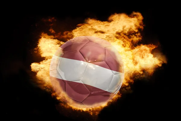 Football ball with the flag of latvia on fire — Stock Photo, Image