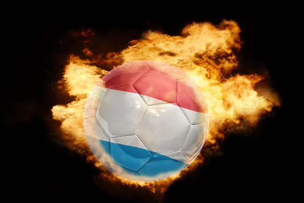 Football ball with the flag of luxembourg on fire — Stock Photo, Image