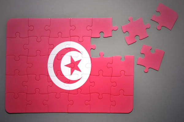 Puzzle mit der Nationalflagge Tunesiens — Stockfoto
