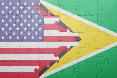 puzzle with the national flag of united states of america and guyana 