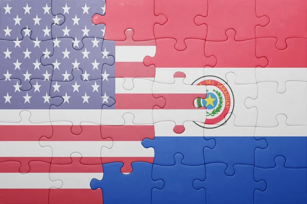 Puzzle with the national flag of united states of america and paraguay — Stok fotoğraf