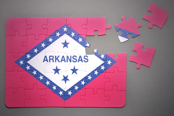Rompecabezas con la bandera del estado de Arkansas — Foto de Stock