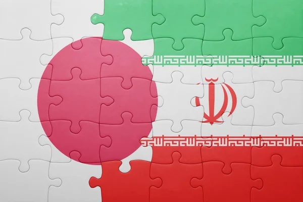 Puzzle with the national flag of iran and japan — Stockfoto