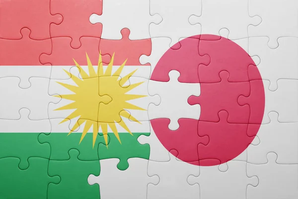 Quebra-cabeça com a bandeira nacional do japão e do Curdistão — Fotografia de Stock