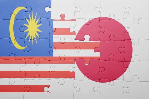 Puzzle with the national flag of japan and malaysia — Stock Photo, Image