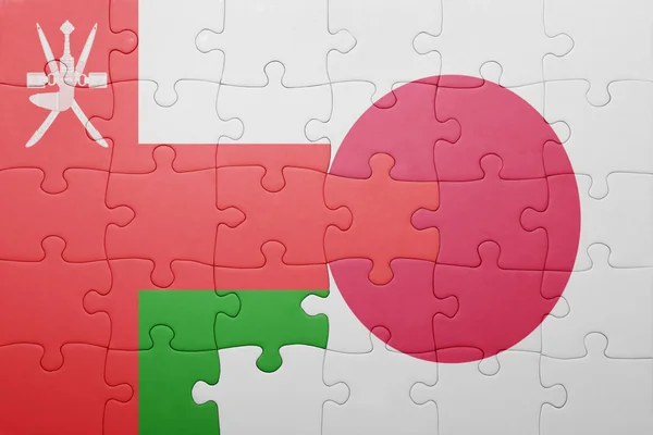 Puzzle with the national flag of japan and oman — Stock Photo, Image