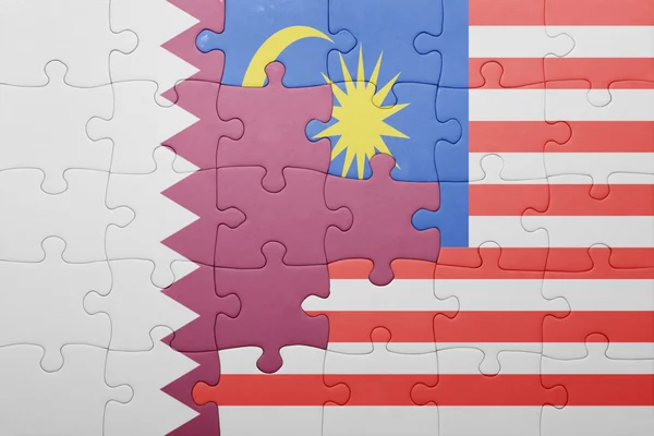 Puzzle with the national flag of malaysia and qatar — Stock Photo, Image