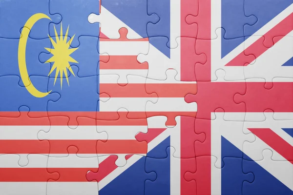 Puzzle con la bandiera nazionale di Gran Bretagna e Malesia — Foto Stock