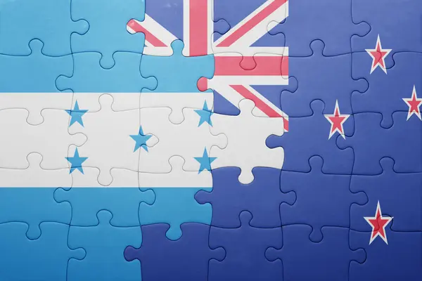 Puzzle avec le drapeau national des honduras et de la Nouvelle-Zélande — Photo