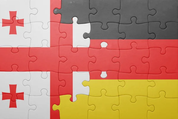 Quebra-cabeça com a bandeira nacional da geórgia e alemanha — Fotografia de Stock