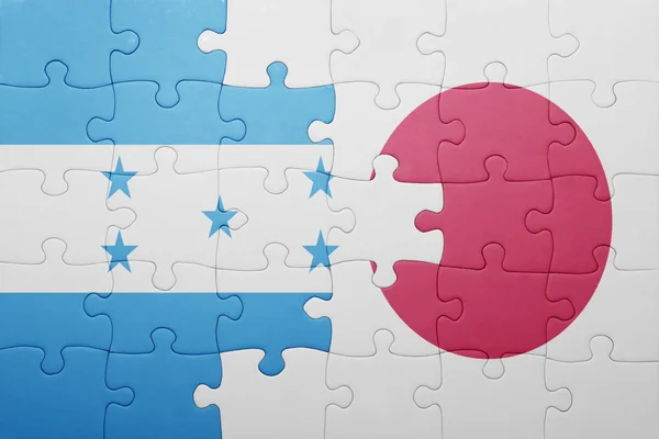 Puzzle avec le drapeau national des honduras et du Japon — Photo