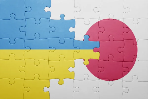 Puzzel met de nationale vlag van Oekraïne en japan — Stockfoto