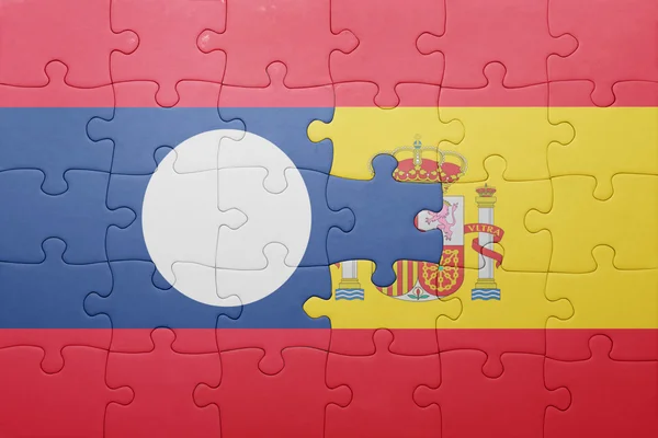 Puzzle with the national flag of spain and laos — Stock Photo, Image