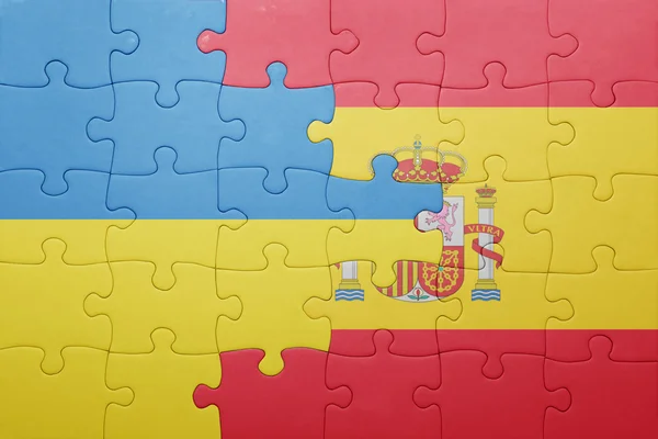 Puzzle with the national flag of spain and ukraine — Stock Photo, Image