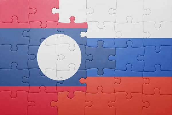 Puzzle with the national flag of laos and russia — Stock Photo, Image
