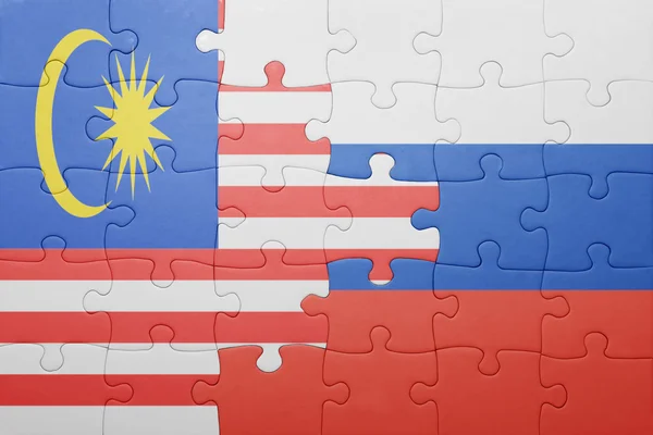 Puzzle with the national flag of malaysia and russia — Stock Photo, Image