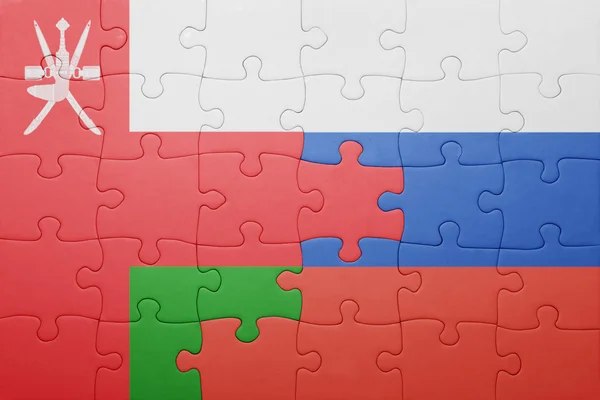 Puzzel met de nationale vlag van oman en Rusland — Stockfoto