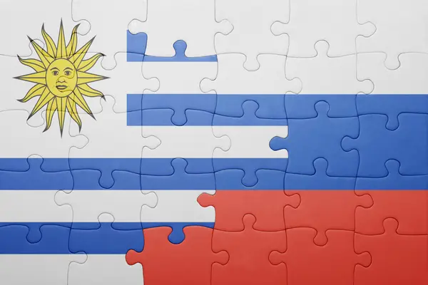 Puzzle with the national flag of uruguay and russia — Stock Photo, Image