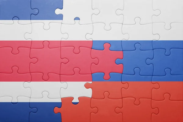 Puzzle with the national flag of costa rica and russia — Stock Photo, Image