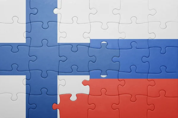 Puzzle with the national flag of finland and russia — Stock Photo, Image