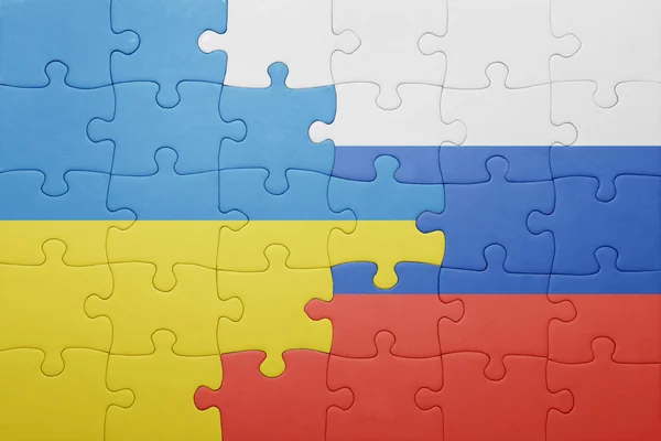 Puzzle with the national flag of ukraine and russia — Stock Photo, Image