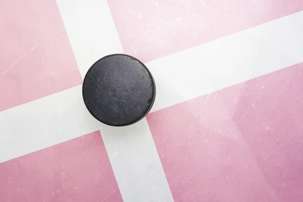 Old hockey puck is on the ice with denmark flag — Stock Photo, Image