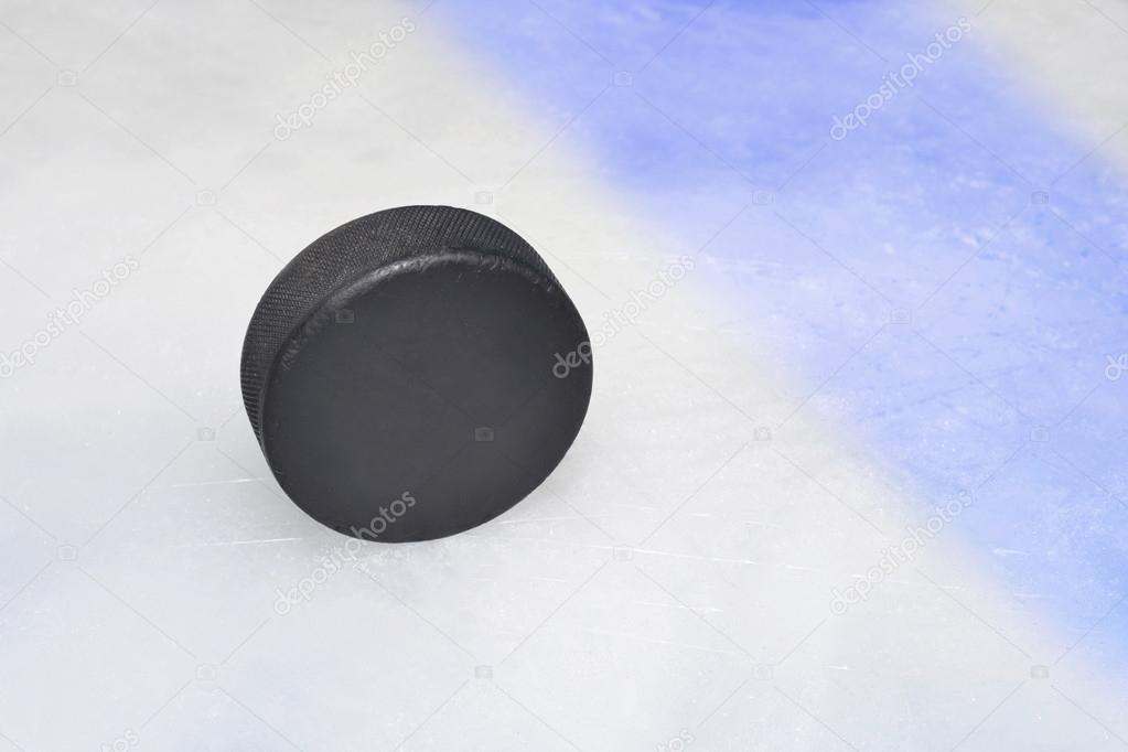 vintage old hockey puck is on the ice