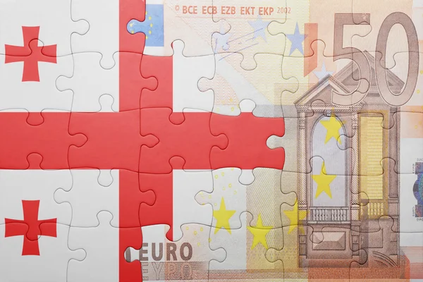 Quebra-cabeças com a bandeira nacional da geórgia e da nota de euro — Fotografia de Stock