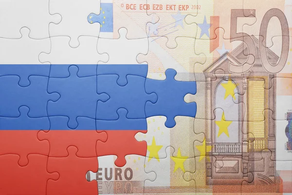 Puzzle with the national flag of russia and euro banknote — Stok fotoğraf