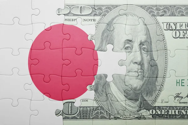 Pussel med den nationella flaggan av japan och dollar sedel — Stockfoto