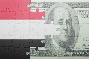 puzzle with the national flag of yemen and dollar banknote