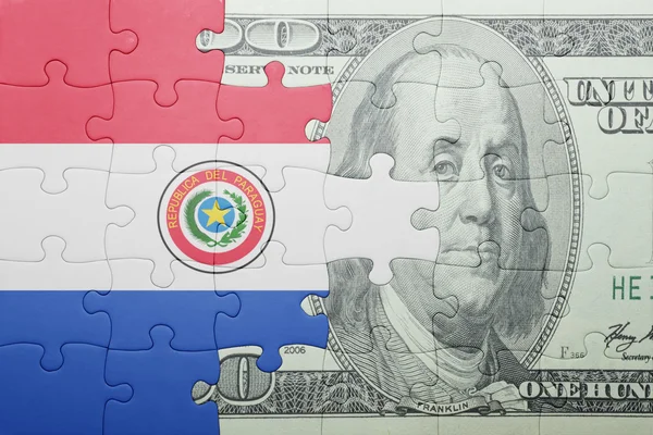 Puzzle mit der Nationalflagge Paraguays und der Dollarnote — Stockfoto