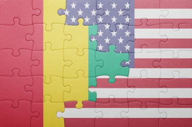 puzzle with the national flag of united states of america and guinea 