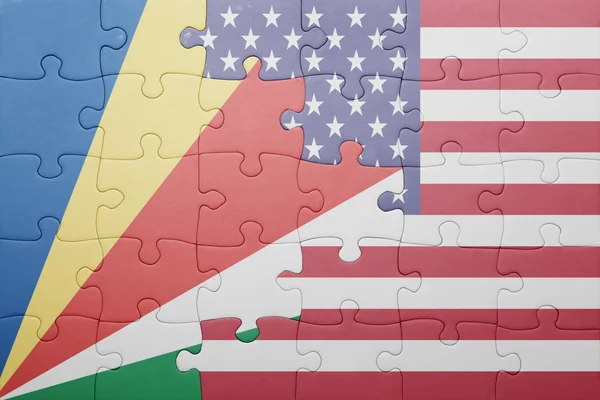 Puzzle with the national flag of united states of america and seychelles — Stock fotografie