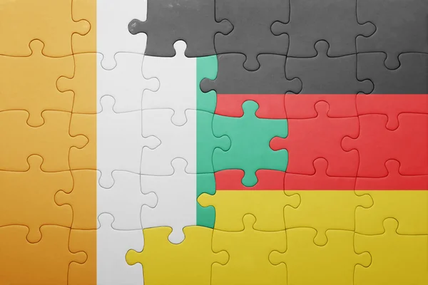 Quebra-cabeça com a bandeira nacional da alemanha e cote divoire — Fotografia de Stock
