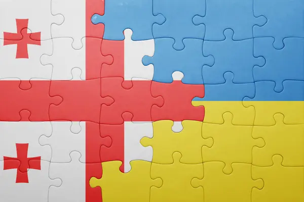Puzzle avec le drapeau national de l'ukraine et de la géorgie — Photo